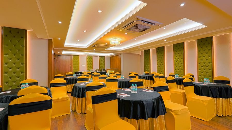 Meeting room with round tables set for a formal event.